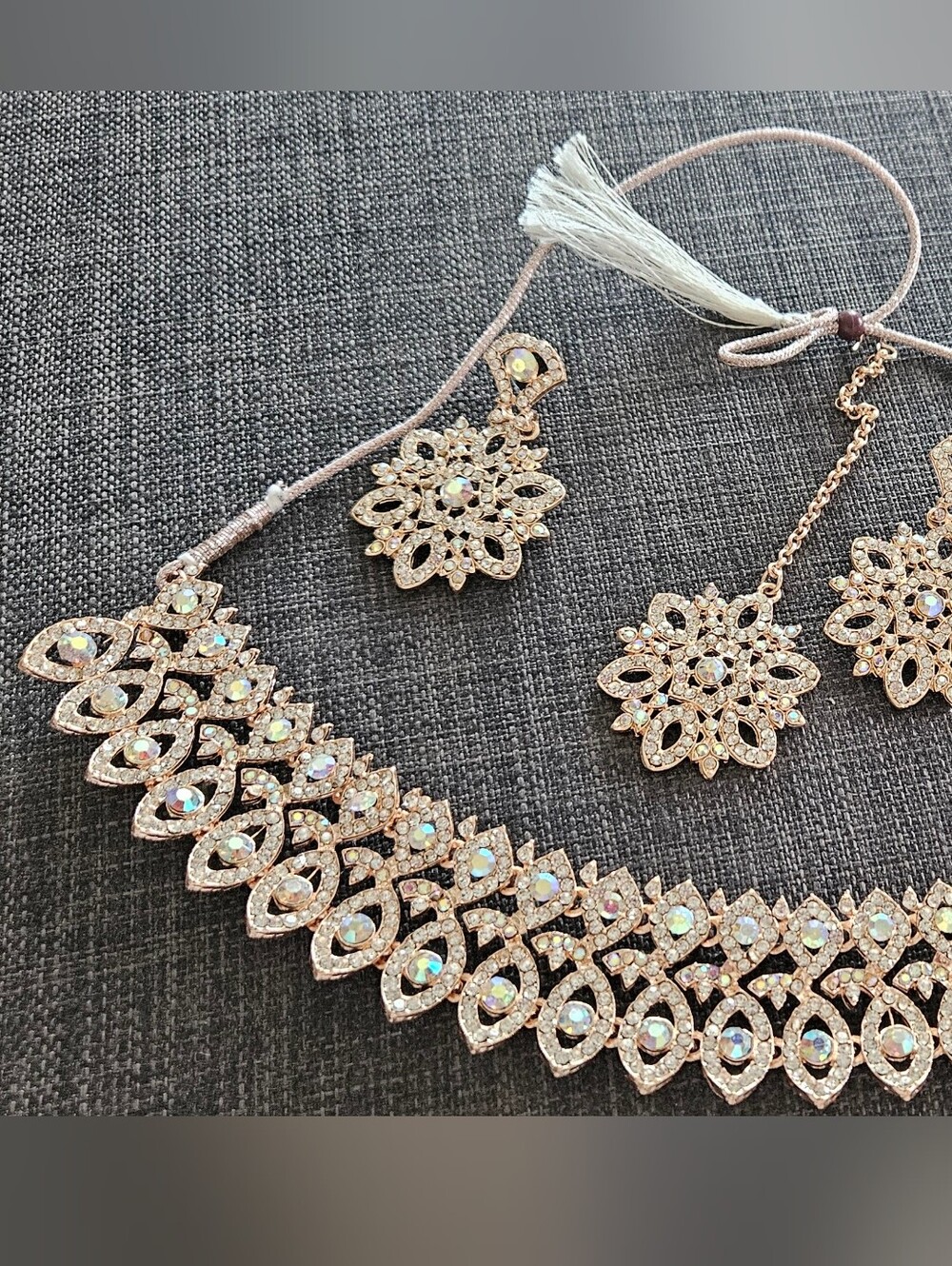 Earrings, necklace, and tikka set with rhinestones